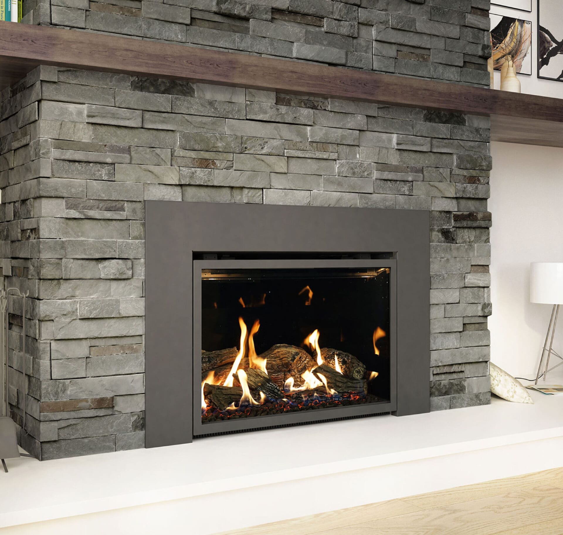 converting wood-burning fireplace to gas-fueled. Gas fireplace insert with gray stone surround and dark wood mantel.